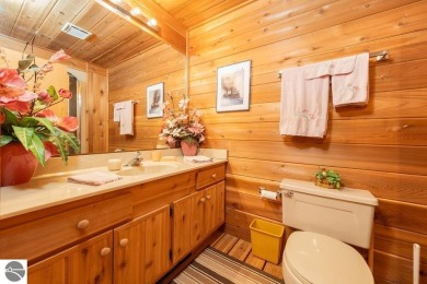 Tucked away in a private setting with frontage on the 13th hole on Schuss Mountain Golf Club in Michigan - for sale on GolfHomes.com, golf home, golf lot