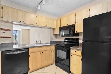 GROUND FLOOR, CORNER UNIT WITH UNOBSTRUCTED GOLF COURSE VIEWS on Feather Sound Country Club in Florida - for sale on GolfHomes.com, golf home, golf lot