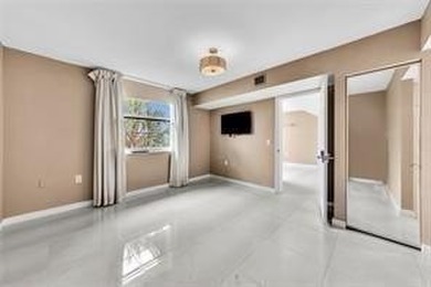 Lakefront Golf Course Condo. Move-in ready and beautifully on Pine Island Ridge Country Club in Florida - for sale on GolfHomes.com, golf home, golf lot