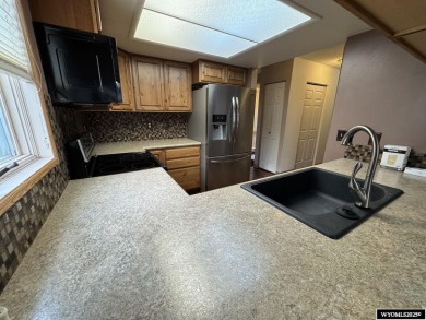 Welcome home to this thoughtfully updated tri-level townhouse on Riverton Country Club in Wyoming - for sale on GolfHomes.com, golf home, golf lot