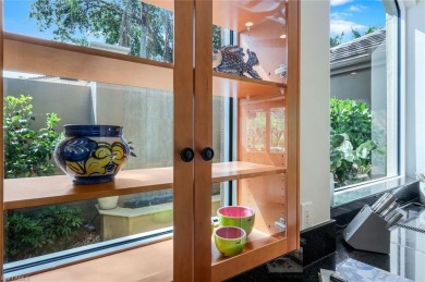 Immerse yourself in the ultimate expression of luxury living at on Shadow Wood Country Club in Florida - for sale on GolfHomes.com, golf home, golf lot