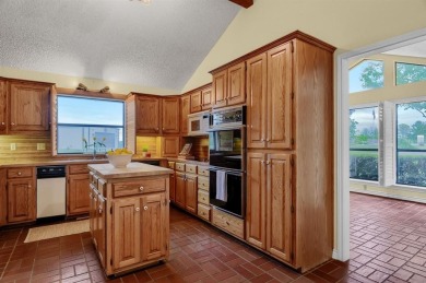 Discover serenity in this custom Stone home situated on over 1.2 on Denison Country Club in Texas - for sale on GolfHomes.com, golf home, golf lot