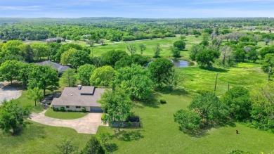 Discover serenity in this custom Stone home situated on over 1.2 on Denison Country Club in Texas - for sale on GolfHomes.com, golf home, golf lot