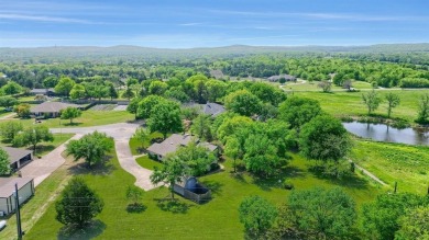 Discover serenity in this custom Stone home situated on over 1.2 on Denison Country Club in Texas - for sale on GolfHomes.com, golf home, golf lot