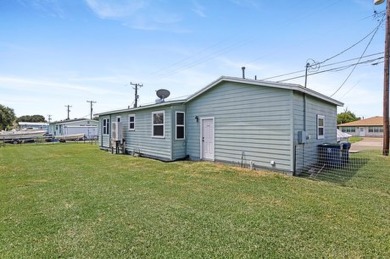 Ride your golf cart to dining, the beach, and downtown from this on Rockport Country Club in Texas - for sale on GolfHomes.com, golf home, golf lot
