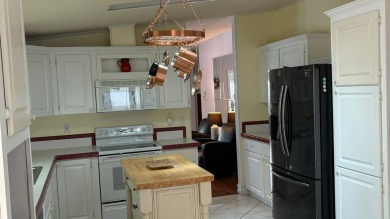 This home has so much to offer!  Pull up to an extended driveway on Sabal Springs Golf and Racquet Club in Florida - for sale on GolfHomes.com, golf home, golf lot