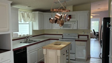 This home has so much to offer!  Pull up to an extended driveway on Sabal Springs Golf and Racquet Club in Florida - for sale on GolfHomes.com, golf home, golf lot