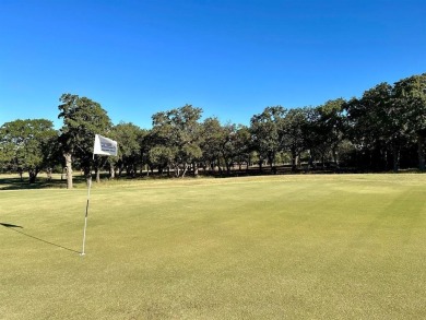 Nice level cleared off half acre lot with mature oak trees on Nocona Hills Golf Course in Texas - for sale on GolfHomes.com, golf home, golf lot
