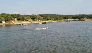 Nice level cleared off half acre lot with mature oak trees on Nocona Hills Golf Course in Texas - for sale on GolfHomes.com, golf home, golf lot