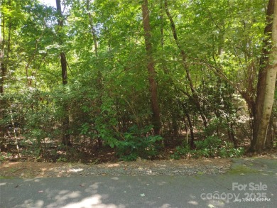 Discover a stunning, sizeable wooded lot in the vibrant mountain on Rumbling Bald Resort on Lake Lure in North Carolina - for sale on GolfHomes.com, golf home, golf lot