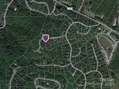 Discover a stunning, sizeable wooded lot in the vibrant mountain on Rumbling Bald Resort on Lake Lure in North Carolina - for sale on GolfHomes.com, golf home, golf lot