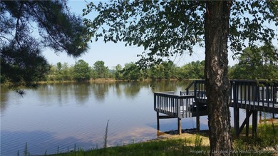 REMODEL WORK UNDERWAY ON THIS WATERFRONT BEAUTY! Please excuse on Woodlake Country Club in North Carolina - for sale on GolfHomes.com, golf home, golf lot