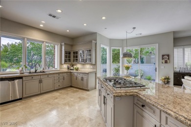 Floor-to-ceiling windows frame the lush greens of the 7th hole on Canyon Gate Country Club in Nevada - for sale on GolfHomes.com, golf home, golf lot