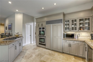 Floor-to-ceiling windows frame the lush greens of the 7th hole on Canyon Gate Country Club in Nevada - for sale on GolfHomes.com, golf home, golf lot