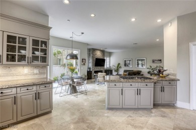 Floor-to-ceiling windows frame the lush greens of the 7th hole on Canyon Gate Country Club in Nevada - for sale on GolfHomes.com, golf home, golf lot