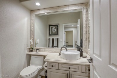 Floor-to-ceiling windows frame the lush greens of the 7th hole on Canyon Gate Country Club in Nevada - for sale on GolfHomes.com, golf home, golf lot