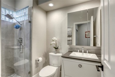 Floor-to-ceiling windows frame the lush greens of the 7th hole on Canyon Gate Country Club in Nevada - for sale on GolfHomes.com, golf home, golf lot