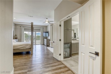 Floor-to-ceiling windows frame the lush greens of the 7th hole on Canyon Gate Country Club in Nevada - for sale on GolfHomes.com, golf home, golf lot