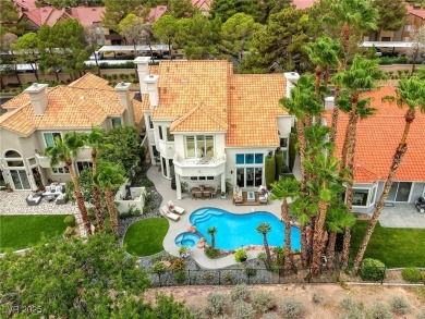 Floor-to-ceiling windows frame the lush greens of the 7th hole on Canyon Gate Country Club in Nevada - for sale on GolfHomes.com, golf home, golf lot