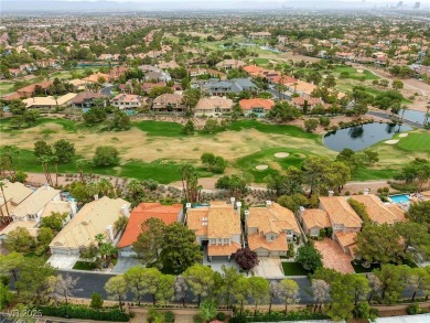 Floor-to-ceiling windows frame the lush greens of the 7th hole on Canyon Gate Country Club in Nevada - for sale on GolfHomes.com, golf home, golf lot