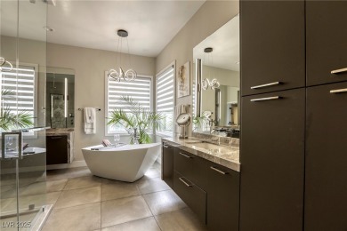 Floor-to-ceiling windows frame the lush greens of the 7th hole on Canyon Gate Country Club in Nevada - for sale on GolfHomes.com, golf home, golf lot