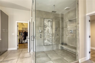 Floor-to-ceiling windows frame the lush greens of the 7th hole on Canyon Gate Country Club in Nevada - for sale on GolfHomes.com, golf home, golf lot