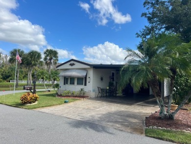 Just beyond the gates of Hidden Golf Club is a perfectly on Lake Henry Golf Club in Florida - for sale on GolfHomes.com, golf home, golf lot