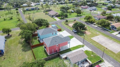 The home is elevated on pilings to allow for covered parking and on Rockport Country Club in Texas - for sale on GolfHomes.com, golf home, golf lot