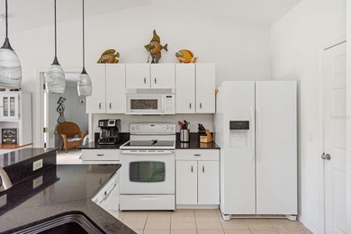 Situated in the desirable Gardens of Gulf Cove, this CANAL-FRONT on Duffys Golf Center in Florida - for sale on GolfHomes.com, golf home, golf lot