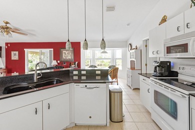 Situated in the desirable Gardens of Gulf Cove, this CANAL-FRONT on Duffys Golf Center in Florida - for sale on GolfHomes.com, golf home, golf lot