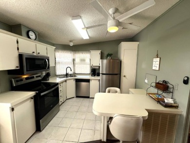 Discover your ideal retreat with this meticulously designed on Lake Henry Golf Club in Florida - for sale on GolfHomes.com, golf home, golf lot