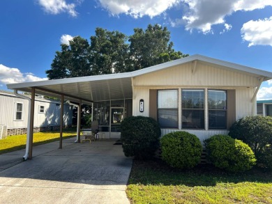This charming home features two bedrooms and one and a half on Lake Henry Golf Club in Florida - for sale on GolfHomes.com, golf home, golf lot