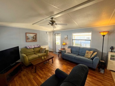 This charming home features two bedrooms and one and a half on Lake Henry Golf Club in Florida - for sale on GolfHomes.com, golf home, golf lot