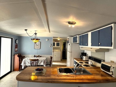 This charming home features two bedrooms and one and a half on Lake Henry Golf Club in Florida - for sale on GolfHomes.com, golf home, golf lot