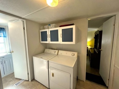 This charming home features two bedrooms and one and a half on Lake Henry Golf Club in Florida - for sale on GolfHomes.com, golf home, golf lot