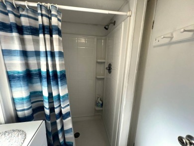 This charming home features two bedrooms and one and a half on Lake Henry Golf Club in Florida - for sale on GolfHomes.com, golf home, golf lot