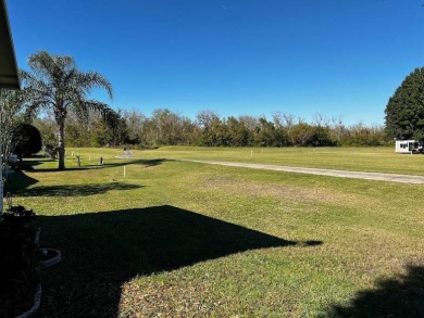 This approx 1200 sf 1990 2 bedroom 2 bath home is located in the on Lake Henry Golf Club in Florida - for sale on GolfHomes.com, golf home, golf lot