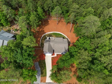 Impeccably maintained, this exquisite home resides on a tranquil on Foxfire Golf and Country Club in North Carolina - for sale on GolfHomes.com, golf home, golf lot