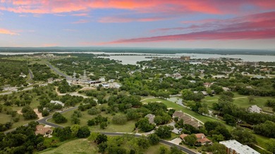 Nestled beneath a canopy of mature trees and overlooking the on Slick Rock Golf Course - Horseshoe Bay in Texas - for sale on GolfHomes.com, golf home, golf lot