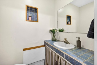 Come see this well-maintained 3-bedroom, 2.5-bath midcentury on Temple Terrace Golf and Country Club in Florida - for sale on GolfHomes.com, golf home, golf lot