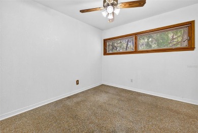Come see this well-maintained 3-bedroom, 2.5-bath midcentury on Temple Terrace Golf and Country Club in Florida - for sale on GolfHomes.com, golf home, golf lot