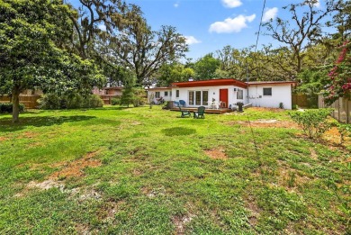 Come see this well-maintained 3-bedroom, 2.5-bath midcentury on Temple Terrace Golf and Country Club in Florida - for sale on GolfHomes.com, golf home, golf lot