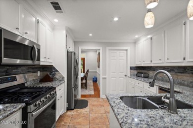 This beautifully maintained 4-bedroom, 2-bath gem nestled in the on Annandale Golf Club in Mississippi - for sale on GolfHomes.com, golf home, golf lot