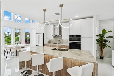 A striking, newly renovated two-story residence showcasing on  in Florida - for sale on GolfHomes.com, golf home, golf lot