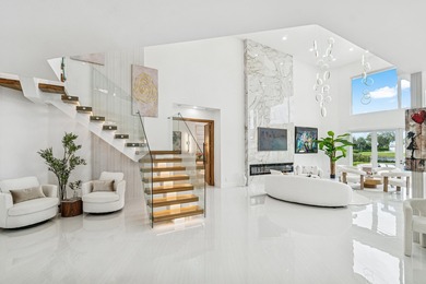 A striking, newly renovated two-story residence showcasing on Polo Club of Boca Raton in Florida - for sale on GolfHomes.com, golf home, golf lot