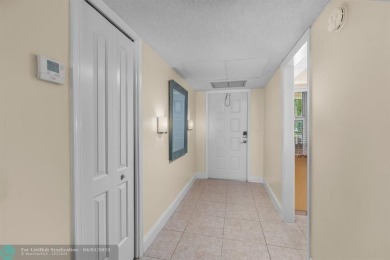 Enjoy a Serene Lake View from this Super Clean, Bright 2nd Floor on Palm-Aire Country Club and Resort - Palms in Florida - for sale on GolfHomes.com, golf home, golf lot