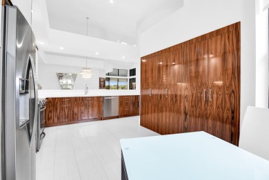 Stunning lake views are the showstopping feature of this on Boca Delray Golf and Country Club in Florida - for sale on GolfHomes.com, golf home, golf lot