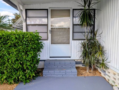 This immaculate home exudes charm and elegance, perfectly on Grasslands Golf and Country Club in Florida - for sale on GolfHomes.com, golf home, golf lot