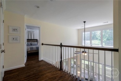 Discover the perfect blend of Southern charm and modern comfort on Great Waters Course At Reynolds Plantation in Georgia - for sale on GolfHomes.com, golf home, golf lot