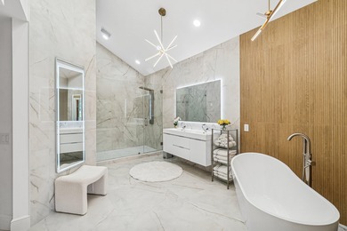 A striking, newly renovated two-story residence showcasing on Polo Club of Boca Raton in Florida - for sale on GolfHomes.com, golf home, golf lot